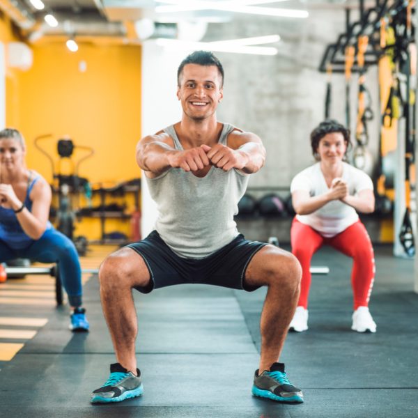 group-people-doing-warm-up-exercise-fitness-club