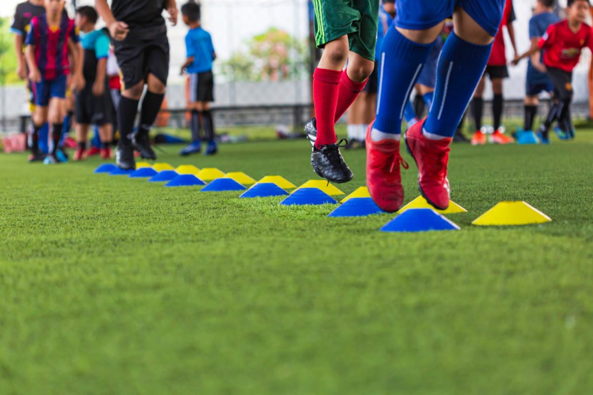soccer-ball-tactics-grass-field-with-barrier-cone-training-children-jump-skill-soccer-academy
